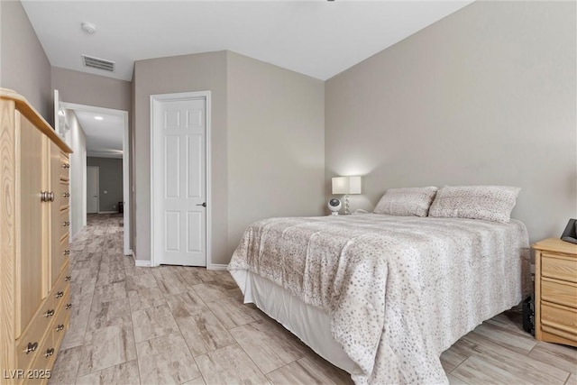 bedroom featuring baseboards and visible vents