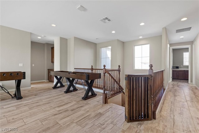 interior space featuring light wood-style floors, recessed lighting, visible vents, and baseboards