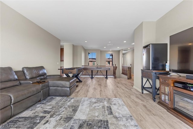 living area featuring light wood finished floors and recessed lighting