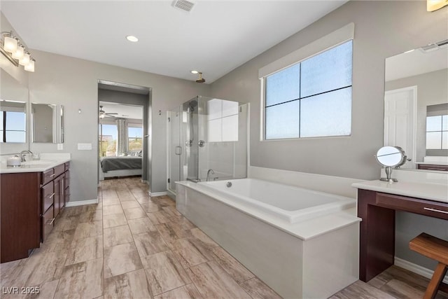 bathroom with visible vents, a shower stall, vanity, and ensuite bathroom