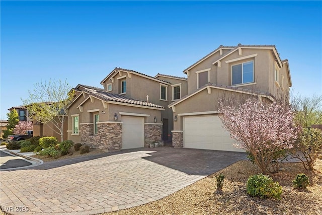 view of front of home with a garage, a tile roof, stone siding, decorative driveway, and stucco siding