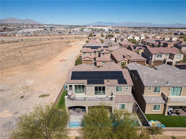 drone / aerial view featuring a residential view and a mountain view