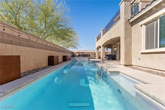 view of pool featuring a patio area, a fenced backyard, and a fenced in pool