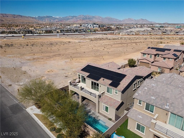 birds eye view of property with a mountain view