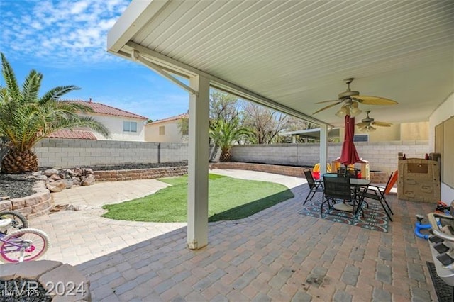 view of patio with ceiling fan, outdoor dining area, and a fenced backyard