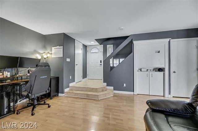 office with baseboards and light wood-style floors