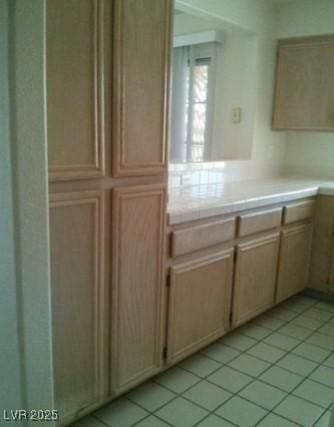 kitchen featuring light tile patterned floors and light countertops