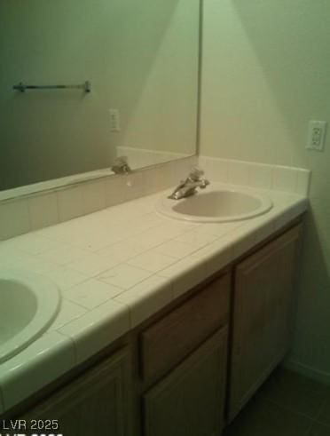 full bathroom with double vanity and a sink