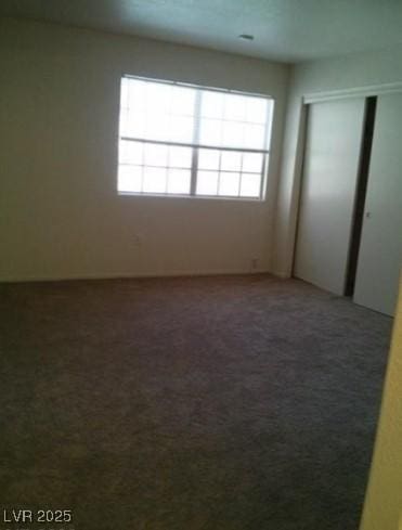 unfurnished bedroom with a closet and carpet flooring