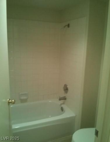 bathroom featuring bathing tub / shower combination and toilet