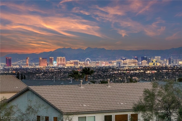 property's view of city with a mountain view