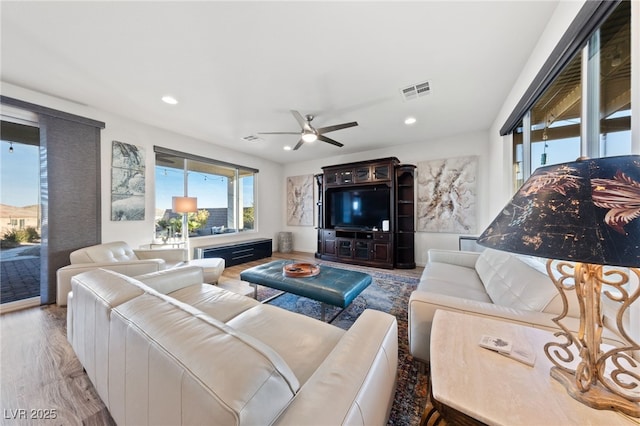 living room with ceiling fan, visible vents, wood finished floors, and recessed lighting