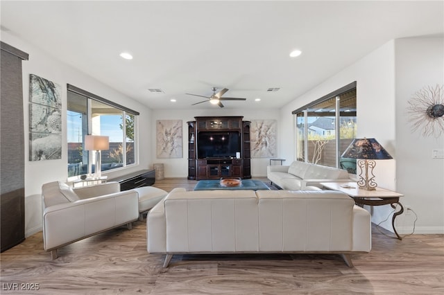 living room featuring wood finished floors, visible vents, and recessed lighting