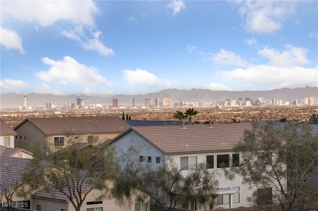 property's view of city with a mountain view