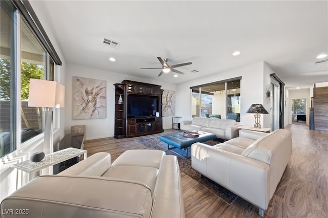 living area featuring visible vents, wood finished floors, and recessed lighting