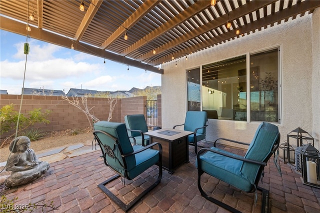 view of patio featuring an outdoor fire pit, fence, and a pergola