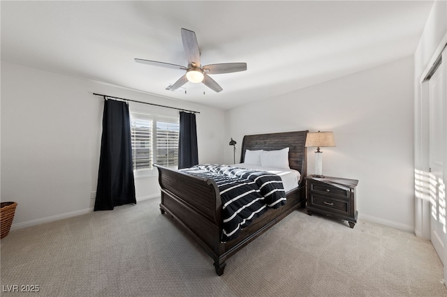 bedroom with ceiling fan, baseboards, and light colored carpet