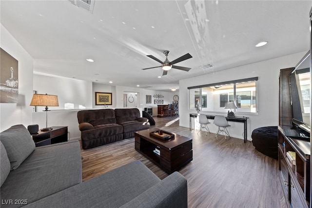 living area with visible vents, wood finished floors, and recessed lighting