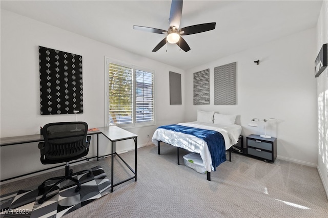 carpeted bedroom with ceiling fan and baseboards