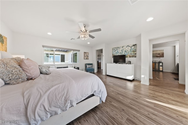 bedroom featuring visible vents, baseboards, a ceiling fan, wood finished floors, and recessed lighting