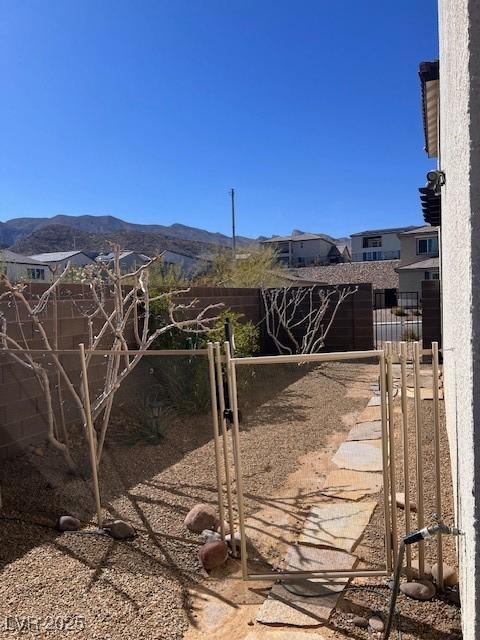 view of gate featuring fence and a mountain view