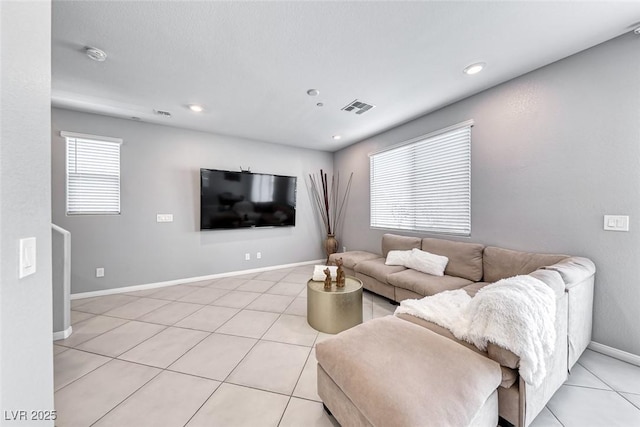 living area featuring recessed lighting, baseboards, visible vents, and light tile patterned flooring