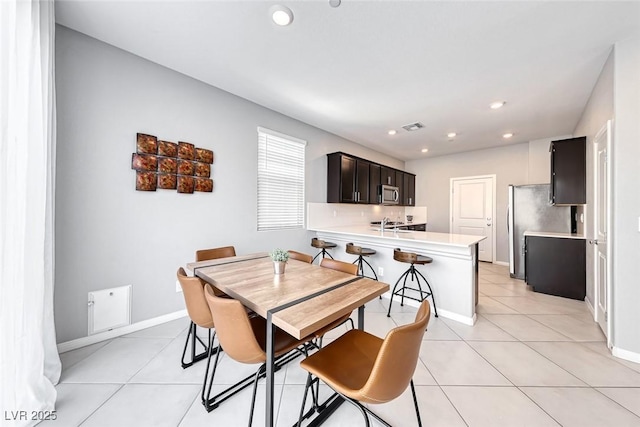 dining area featuring light tile patterned floors, baseboards, visible vents, and recessed lighting