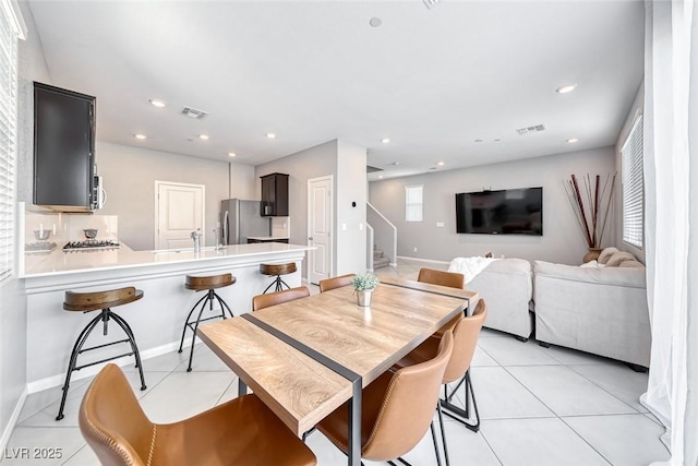 dining area with light tile patterned floors, stairway, visible vents, and recessed lighting