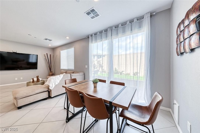 dining area with light tile patterned floors, recessed lighting, visible vents, and baseboards