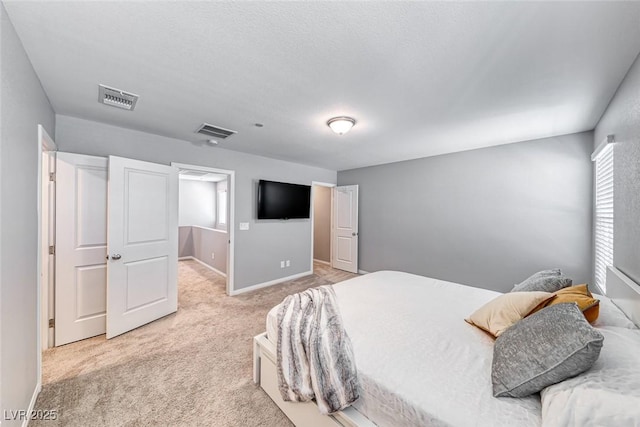 bedroom featuring baseboards, visible vents, and carpet flooring