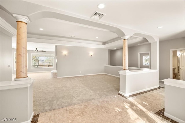interior space featuring visible vents, ornate columns, baseboards, recessed lighting, and light colored carpet