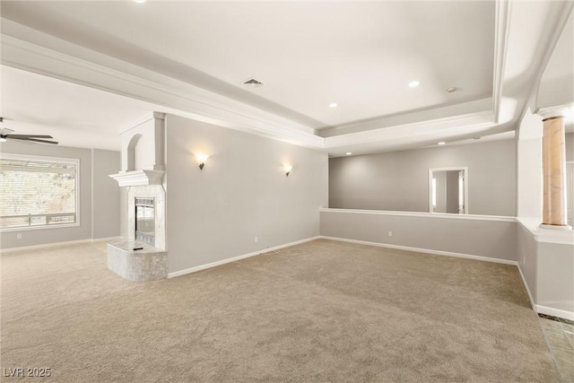 basement featuring baseboards, carpet floors, visible vents, and a ceiling fan