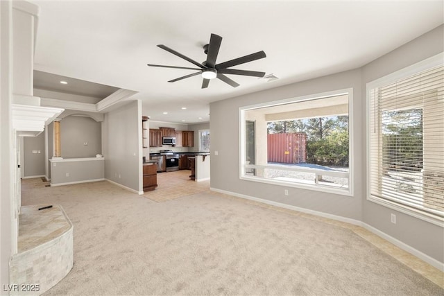 unfurnished living room featuring recessed lighting, light carpet, baseboards, and ceiling fan