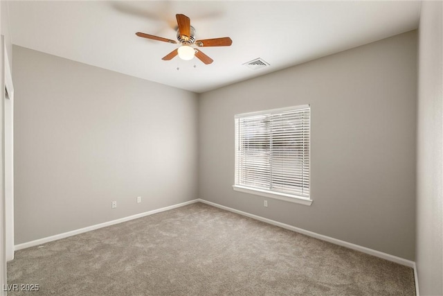 carpeted empty room with visible vents, baseboards, and ceiling fan