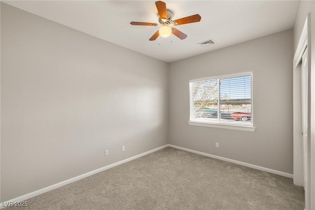 unfurnished bedroom featuring baseboards, a ceiling fan, visible vents, and carpet