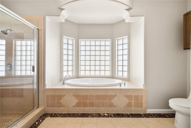 full bathroom with a stall shower, baseboards, toilet, and a bath