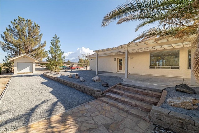 view of patio / terrace with an outdoor structure and a garage