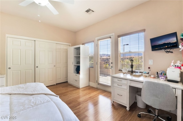 bedroom with visible vents, light wood-style flooring, ceiling fan, access to exterior, and a closet