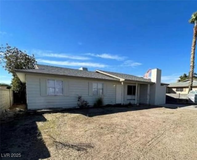 back of property featuring fence