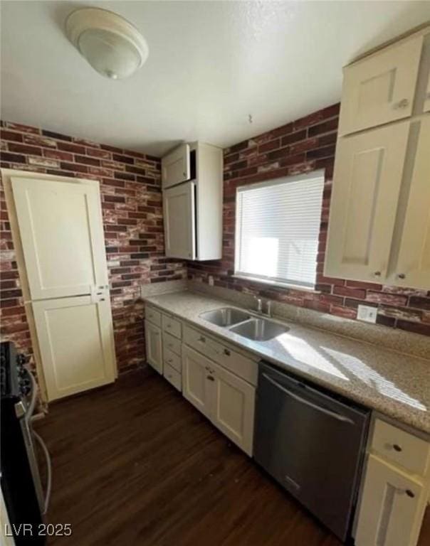 kitchen with brick wall, dark wood-style flooring, range, and stainless steel dishwasher