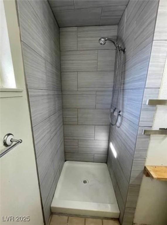 full bathroom with a tile shower