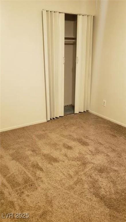 unfurnished bedroom with carpet, baseboards, and a closet