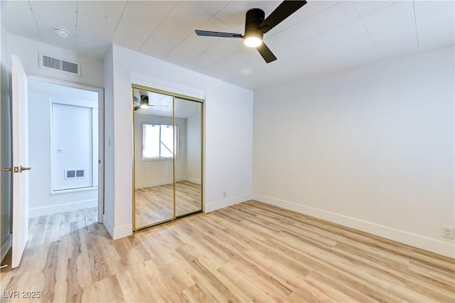 unfurnished bedroom featuring light wood-style floors, baseboards, and visible vents