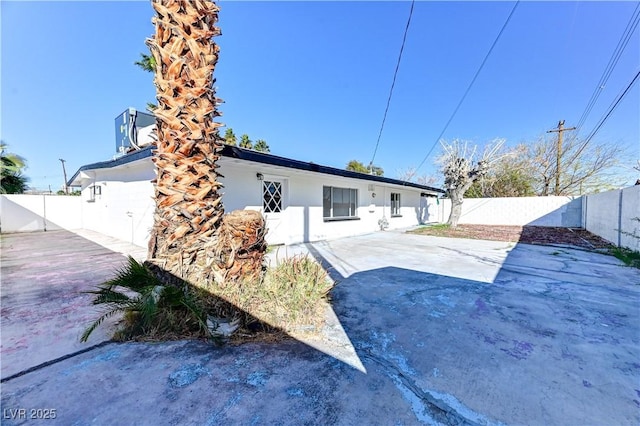 back of house featuring a patio area, a fenced backyard, and stucco siding