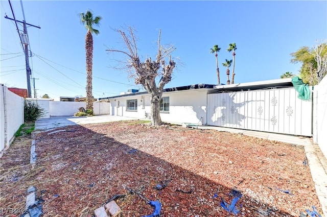 back of property featuring stucco siding, a fenced backyard, and a patio