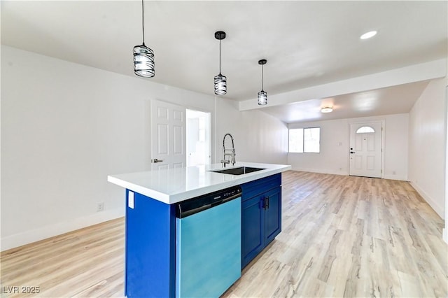 kitchen featuring light countertops, a sink, blue cabinets, light wood-type flooring, and dishwasher