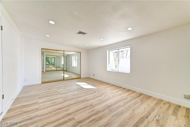 spare room with recessed lighting, visible vents, and light wood-style flooring