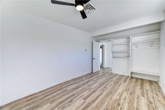 unfurnished bedroom featuring a closet, ceiling fan, light wood-style flooring, and baseboards