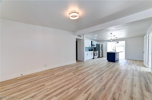 unfurnished living room featuring recessed lighting, a sink, visible vents, baseboards, and light wood-type flooring