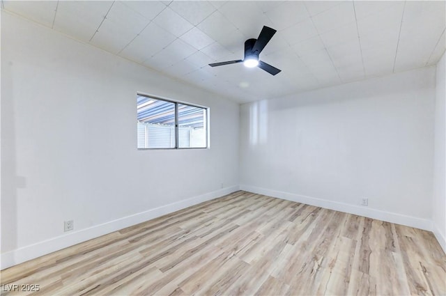 unfurnished room featuring a ceiling fan, baseboards, and wood finished floors